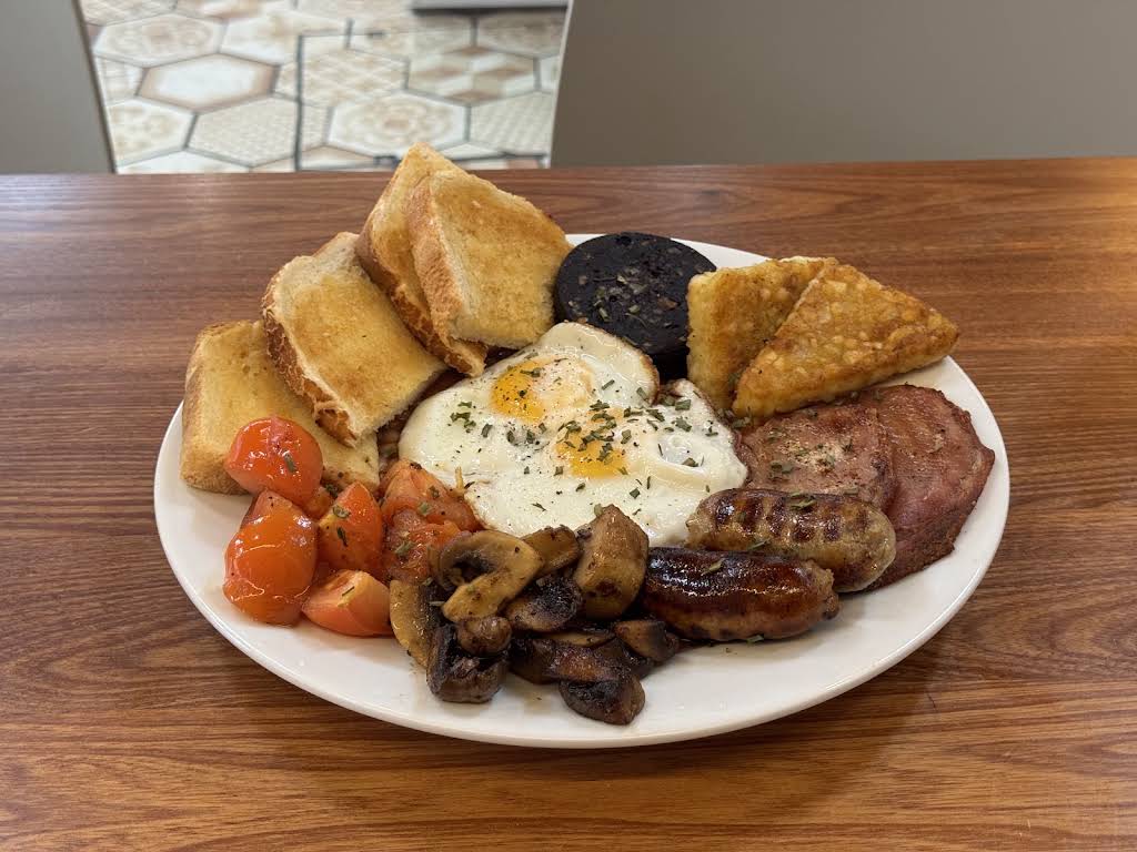 Cafe 25’s breakfast plate with eggs, toast, sausage, bacon, mushrooms, tomatoes and hash browns.
